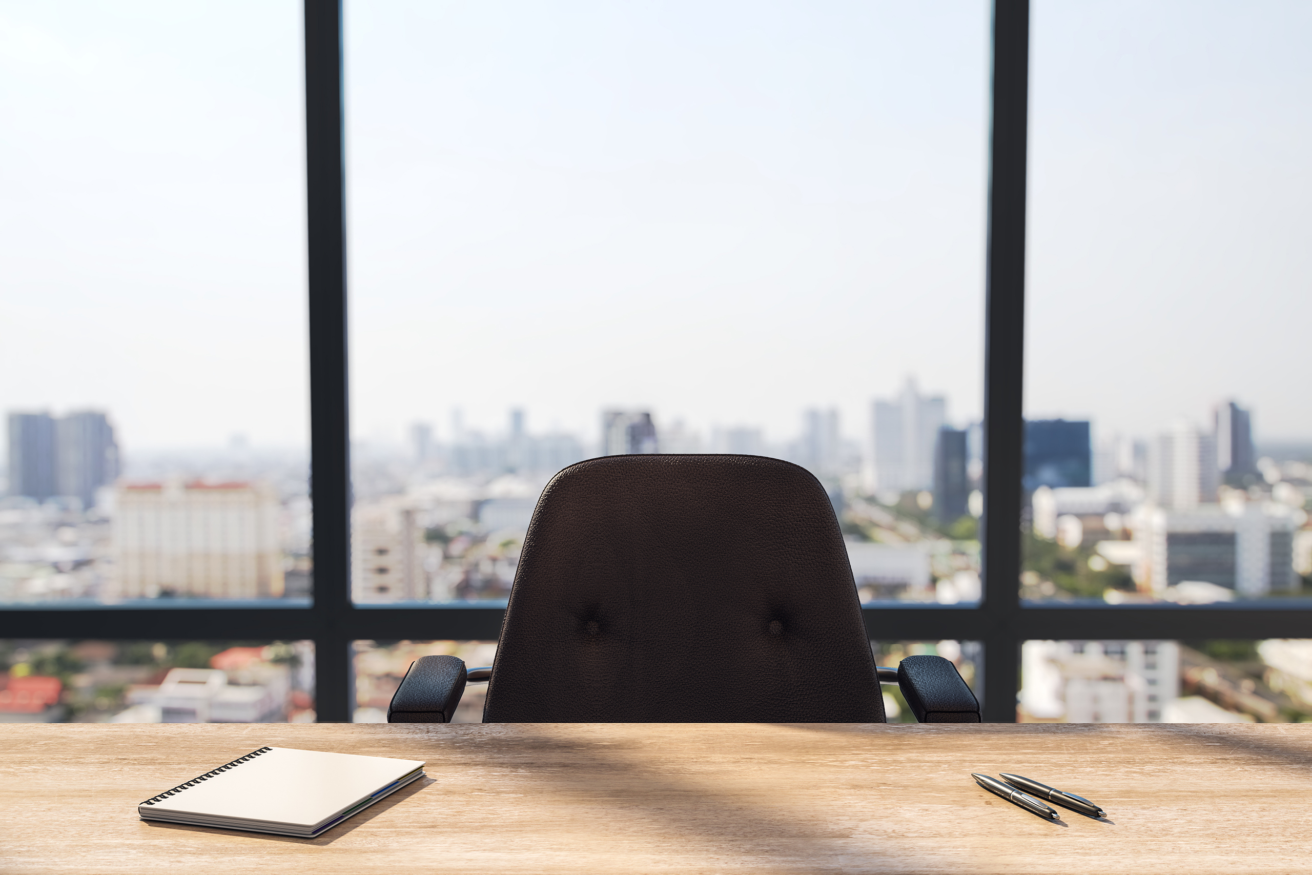 Empty office chair overlooking a city skyline, a Head of HR vacancy that fractional HR services can fill